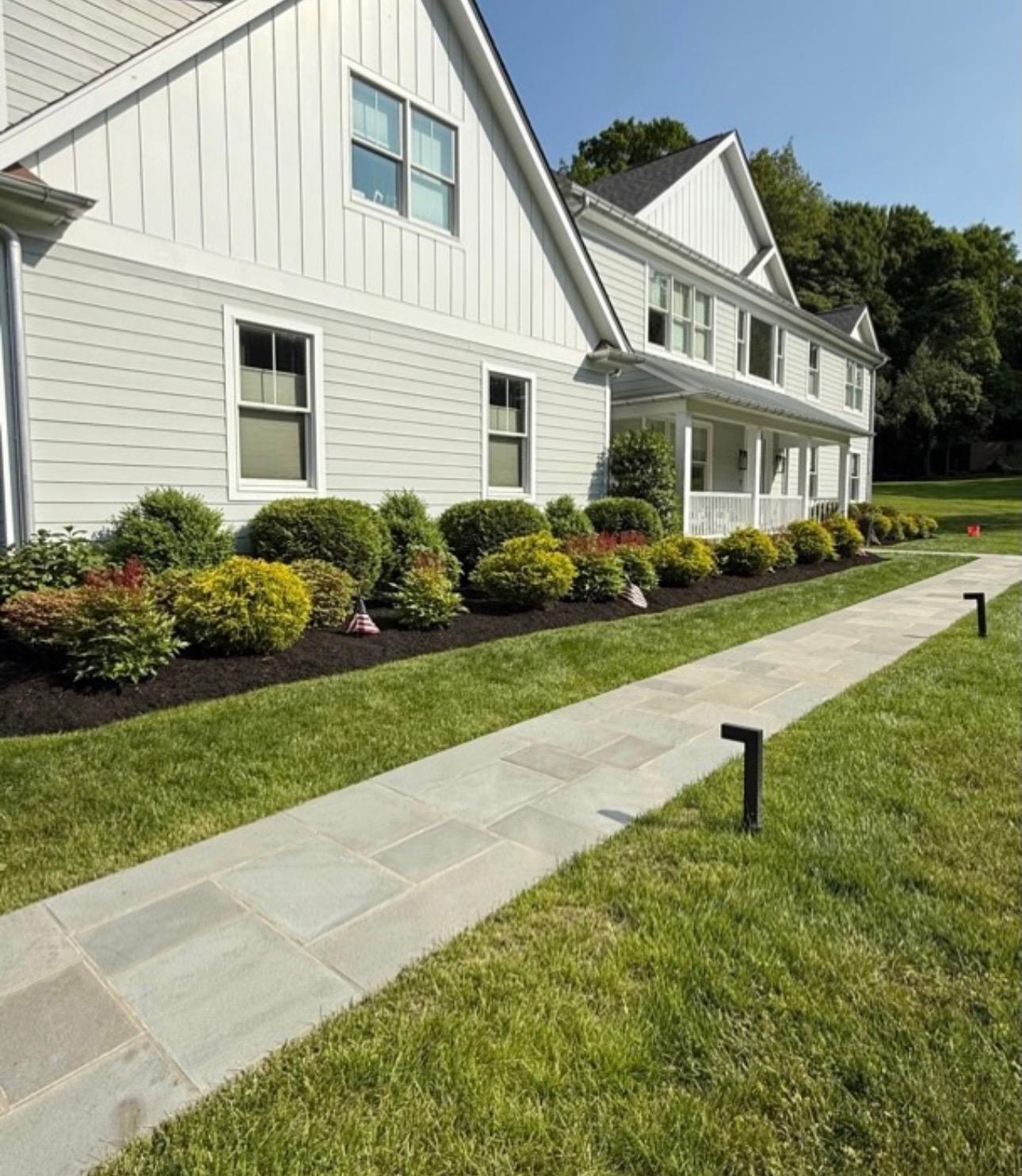Manicured lawn with fresh mulch beds along a Kitchener home