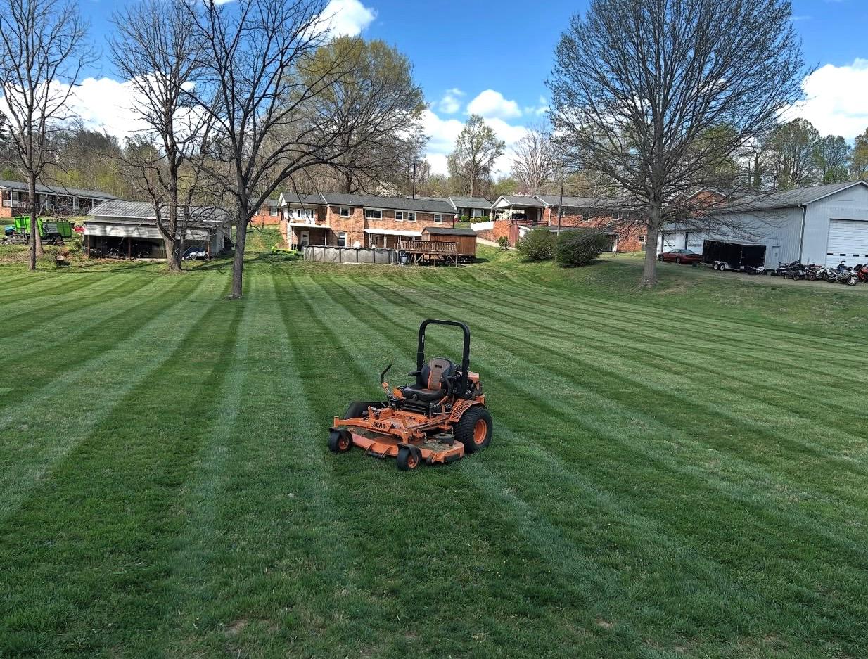 Professional zero-turn mower on a striped lawn in Cambridge ON