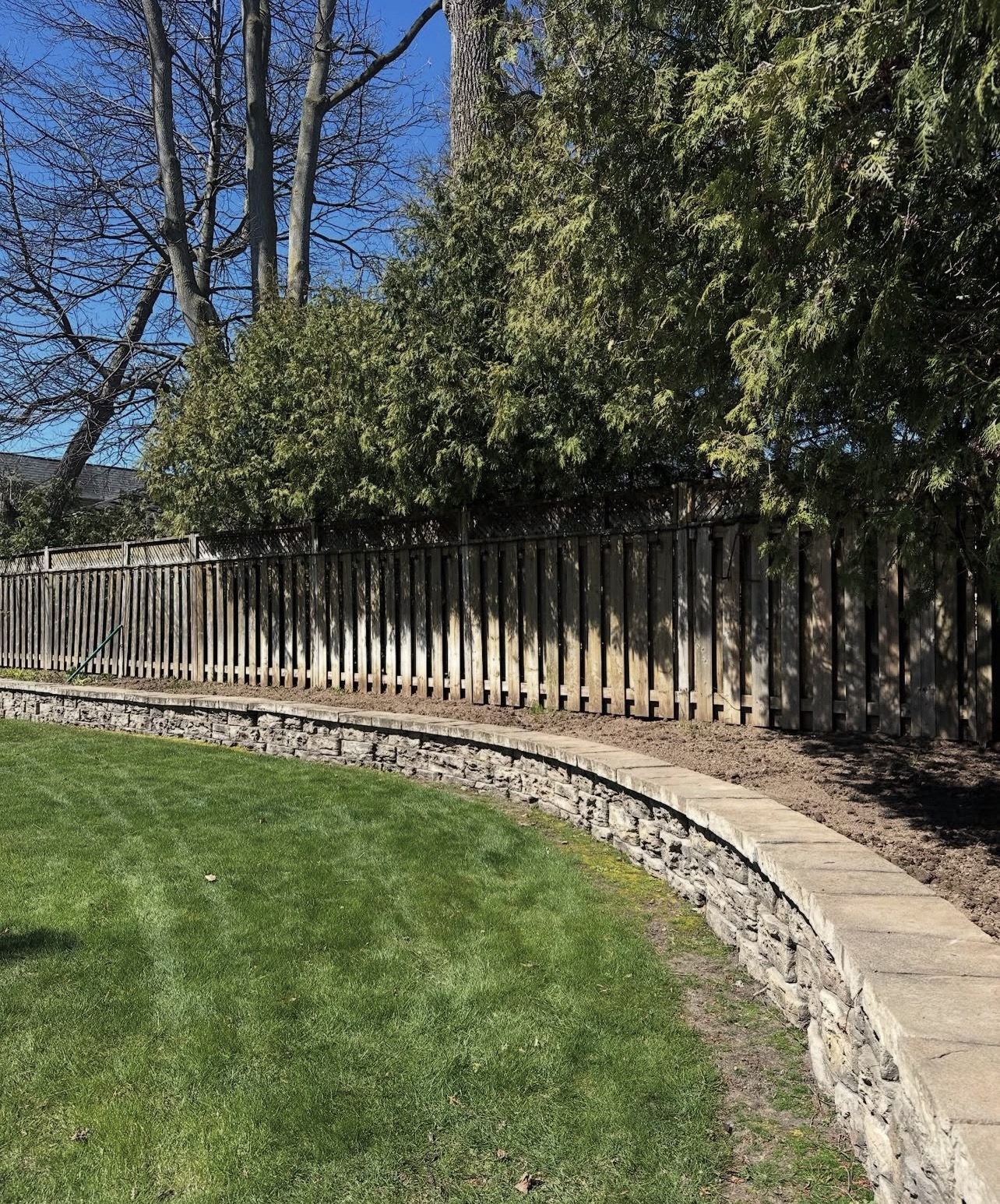 Curved natural-stone wall — TriCity Landscaping of Kitchener project in Stanley Park, Kitchener ON